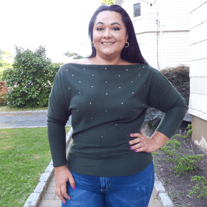 The Open Shoulder Embellished Plus Size Sweater is perfect for cooler weather. It features a silver pearl embellishment and a unique open shoulder design.