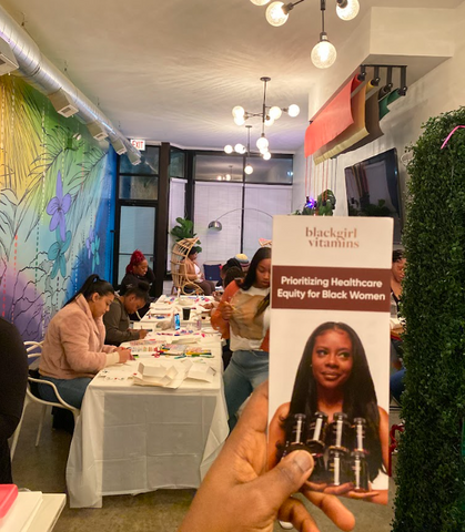 woman holding a flyer for black girl vitamins