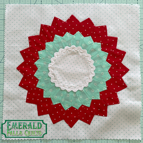 flower like circle with red, teal, and white