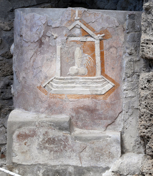 Relief of winged phallus on altar in Via dell'Abbondanza in Pompeii