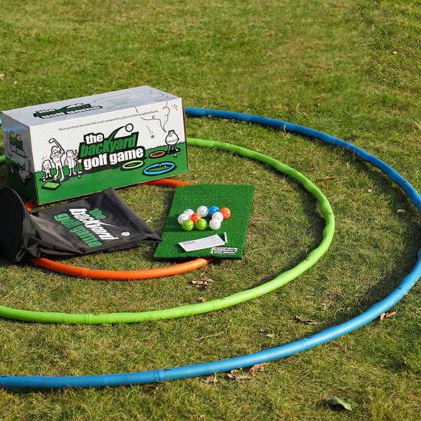 Picture showing the contents of The Backyard Golf Game which contains 3 different size rings, Wiffle golf balls, a chipping mat & a carrying case