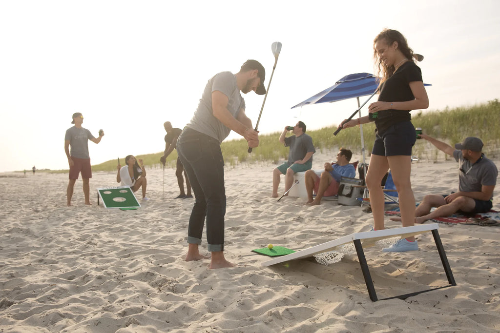 Group of adults playing Chippo backyard golf game at the beach