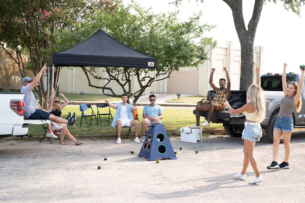 Group of friends hanging out at a  tailgate playing TowerBall the best tailgate game