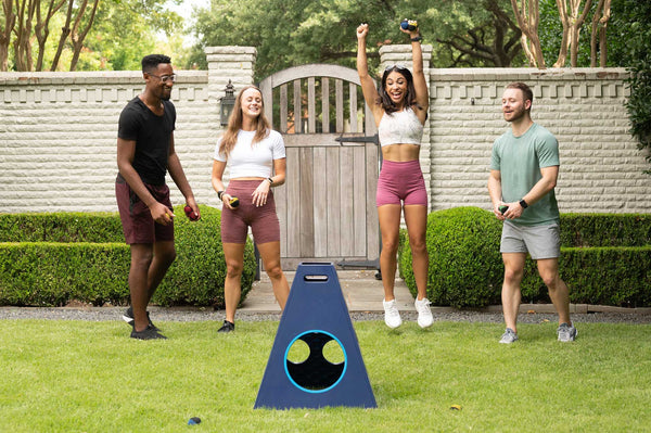 Group of friends playing Towerball, the yard game perfect for parties, weddings & tailgates