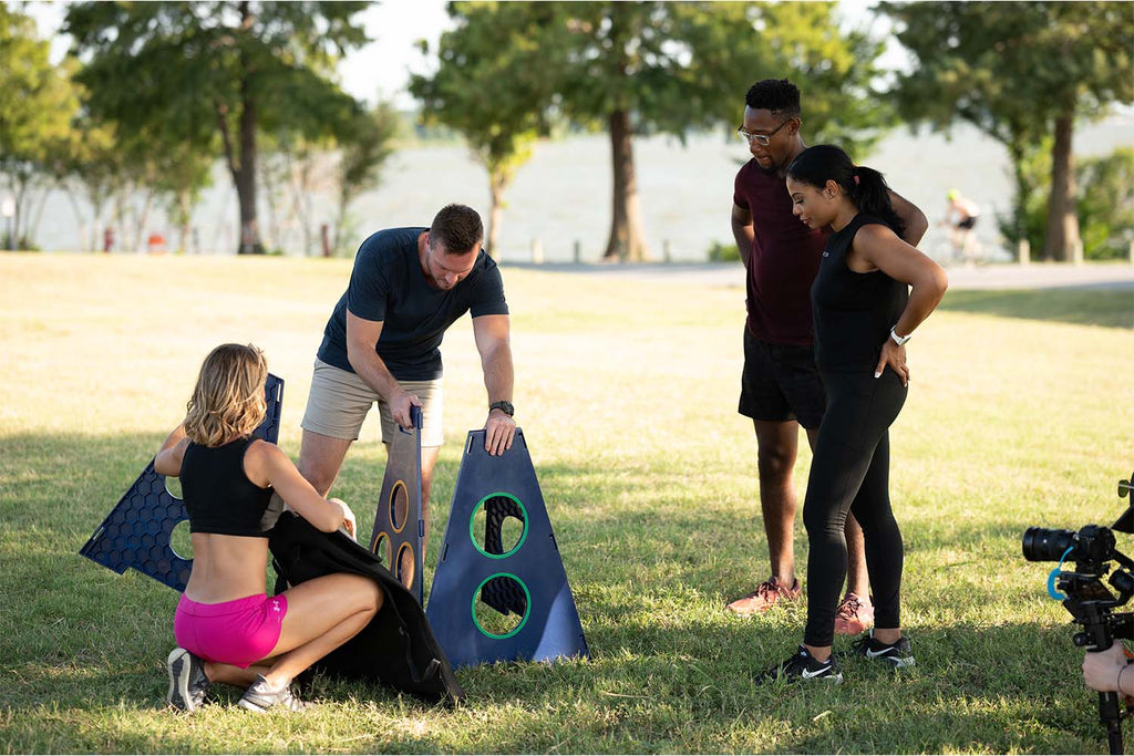 Group of adults easily setting up TowerBall an icebreaker game outside