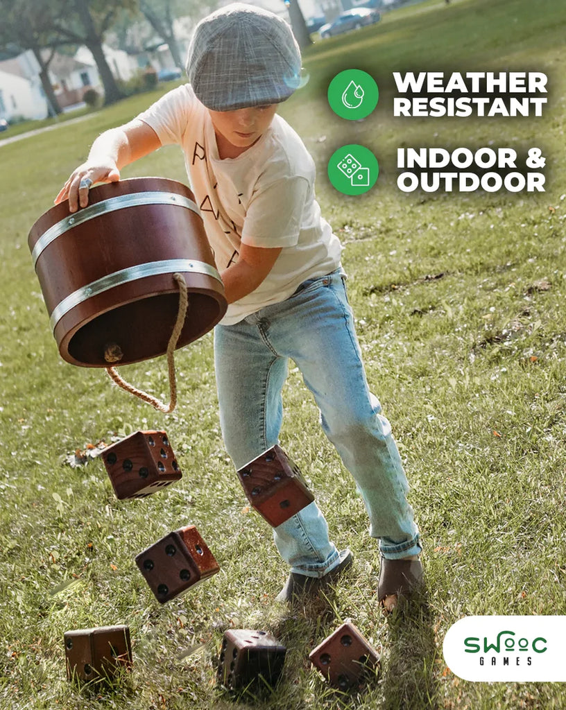 Image of boy holding wooden bucket playing Yardzee game at the park 