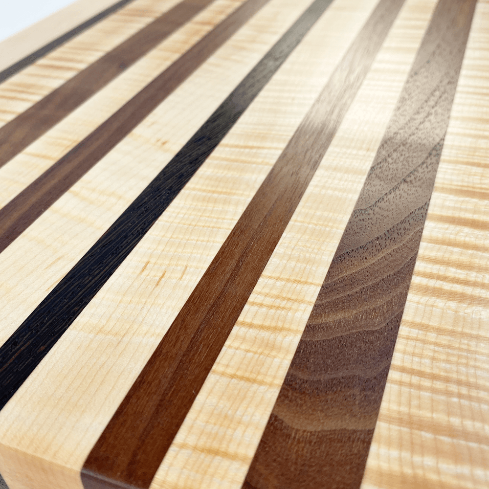 Black Walnut and Curly Maple Edge Grain Cutting Board with Stripe of W