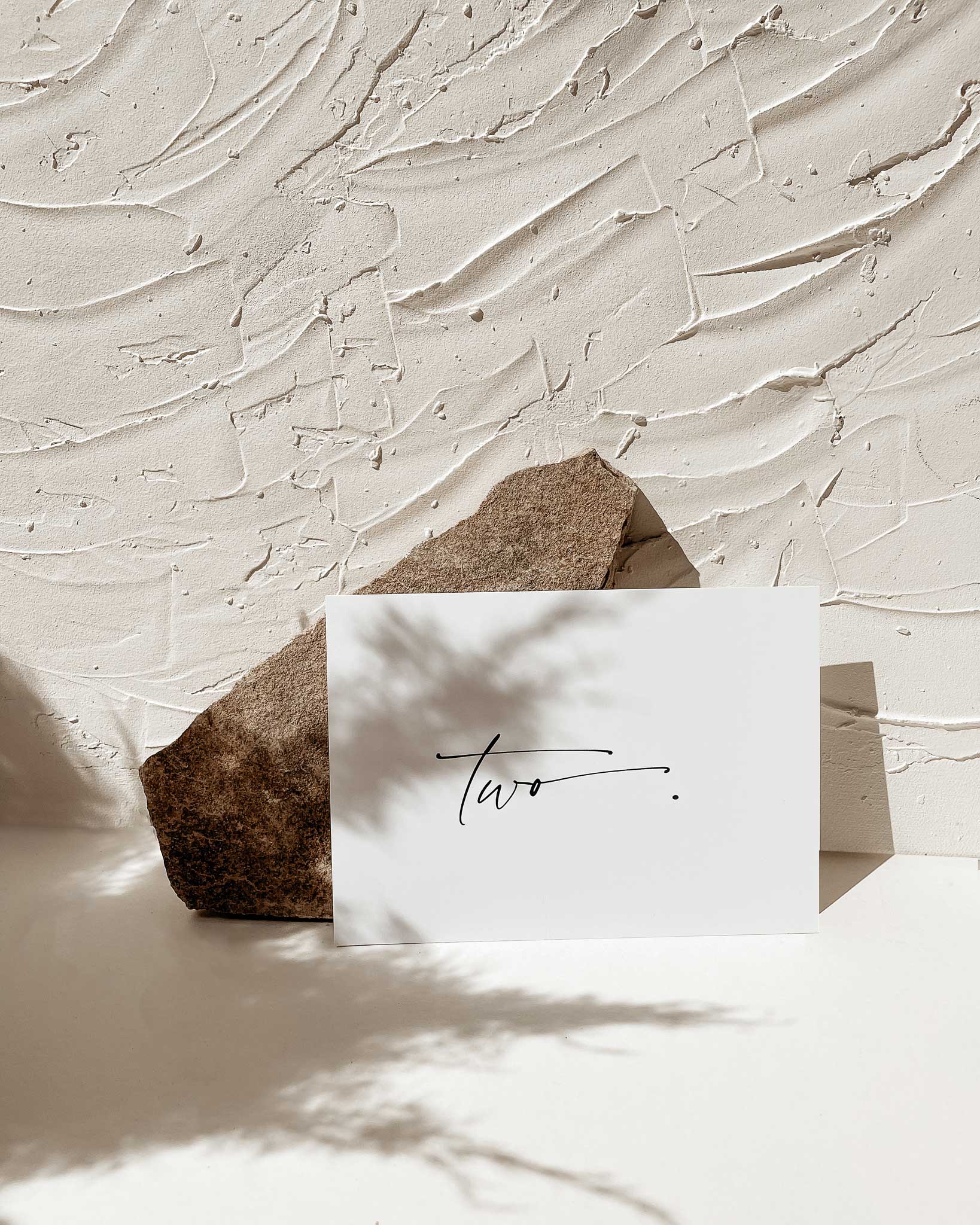 table number card leaning on jagged stone