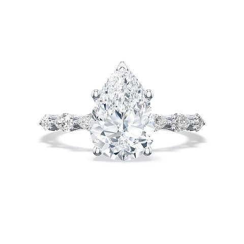 a white gold ring with a pear shaped center diamond and small pear shaped diamonds on the band