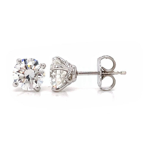 Four prong diamond stud earrings with design on the side profile