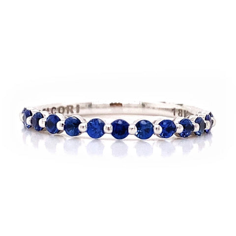a sapphire band in white gold with shared prongs