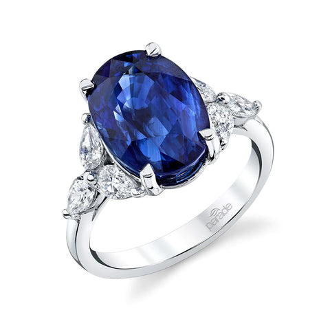 an oval cut blue sapphire set into white gold with 3 diamonds on each side