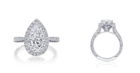 a pear shaped diamond engagement ring with a halo setting