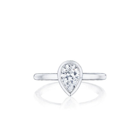 a pear shaped diamond in a bezel solitaire setting
