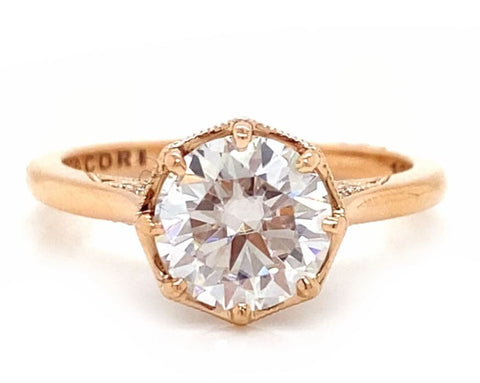 a round cut moissanite is set into rose gold