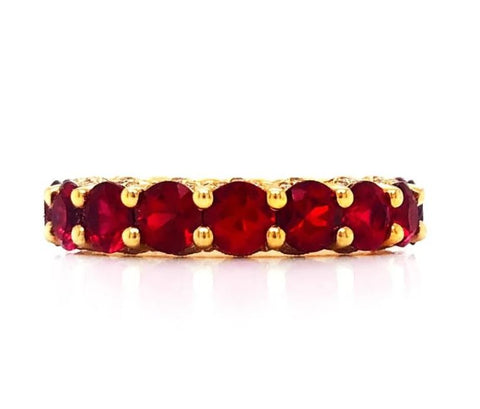 a ruby eternity band in yellow gold