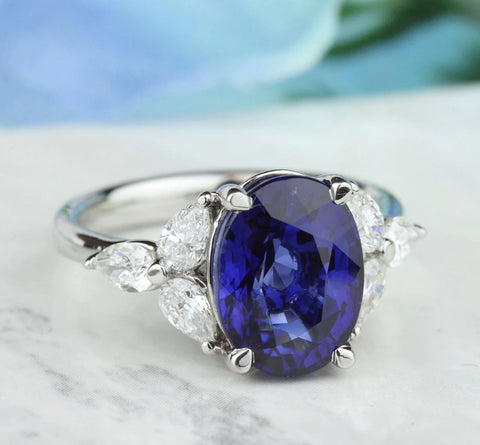 an oval cut blue sapphire with marquise cut diamonds on the sides