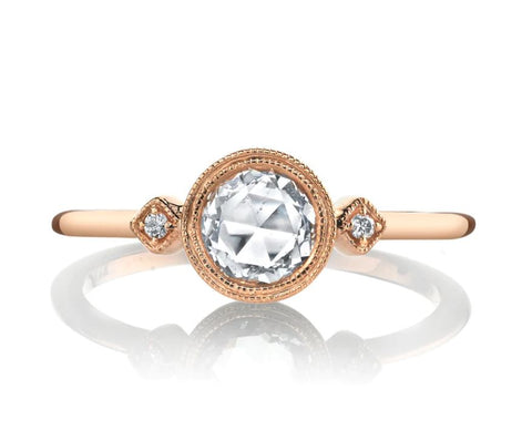 a rose cut diamond is the feature stone in this rose gold engagement ring with a knife edge band