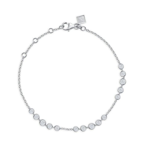 a white gold chain link bracelet set with sections of bezel set round cut diamonds