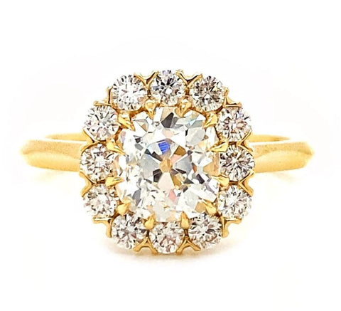 a yellow gold halo engagement ring with an old mine cut diamond