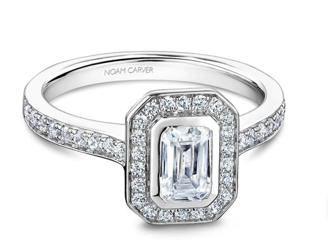 a white gold engagement ring with an emerald cut diamond