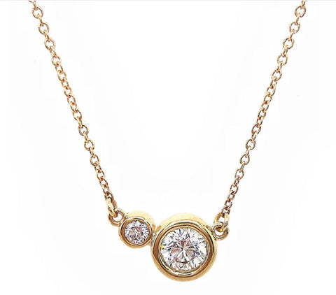 a diamond necklace with bezel set diamonds