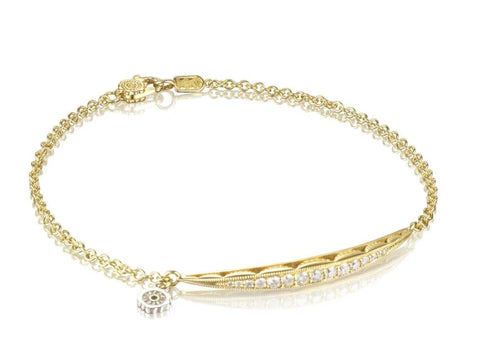 a yellow gold chain link bracelet with a surfboard shaped section of diamonds