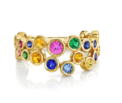 a yellow gold "bubble" style ring with various colored sapphires