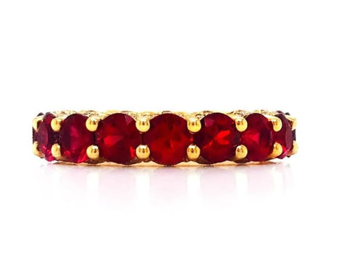 rubies are set into a yellow gold eternity band style ring