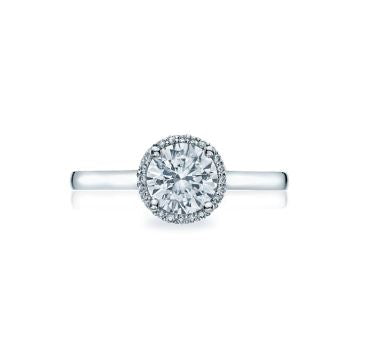 a white gold engagement ring with a round diamond and halo