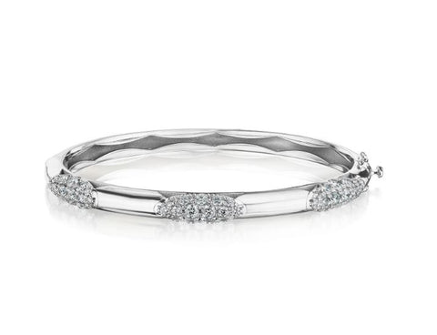 a white gold diamond bangle with sections of diamonds