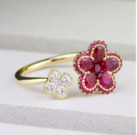 rubies make a floral design on a yellow gold band accented by a smaller flower of diamonds