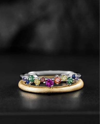 a rainbow stacking ring with a simple yellow gold band