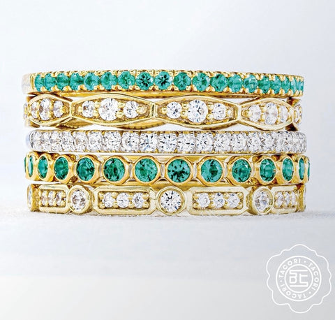 diamond and emerald stacking rings in yellow gold