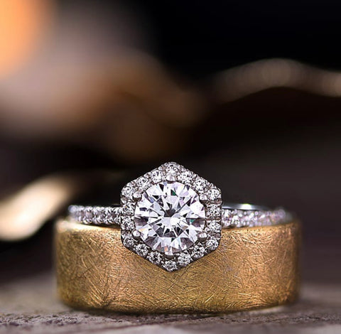 a white gold engagement ring with a geometric shaped halo of diamonds