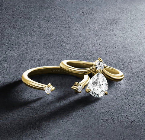 a yellow gold engagement ring with a negative space wedding band