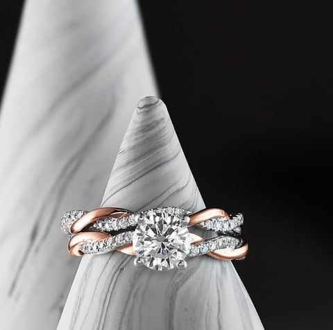 White and rose gold ribbon engagement ring and wedding band