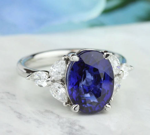 a blue sapphire set with three marquise cut diamonds on each side
