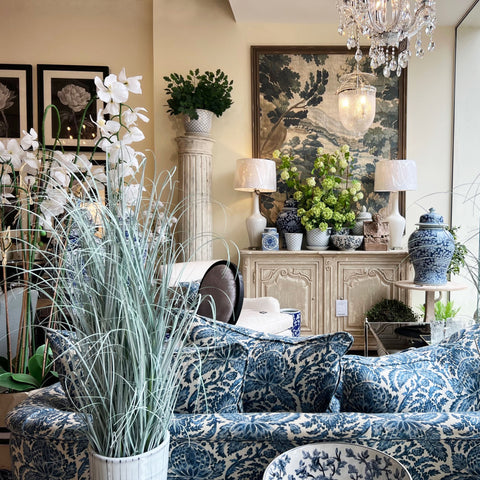 A homeware store selling neutral and blue furniture, lamps ornaments and plants