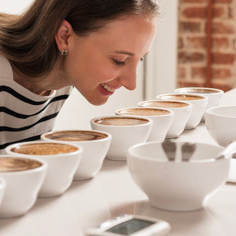 Ashley taste testing and cupping coffee