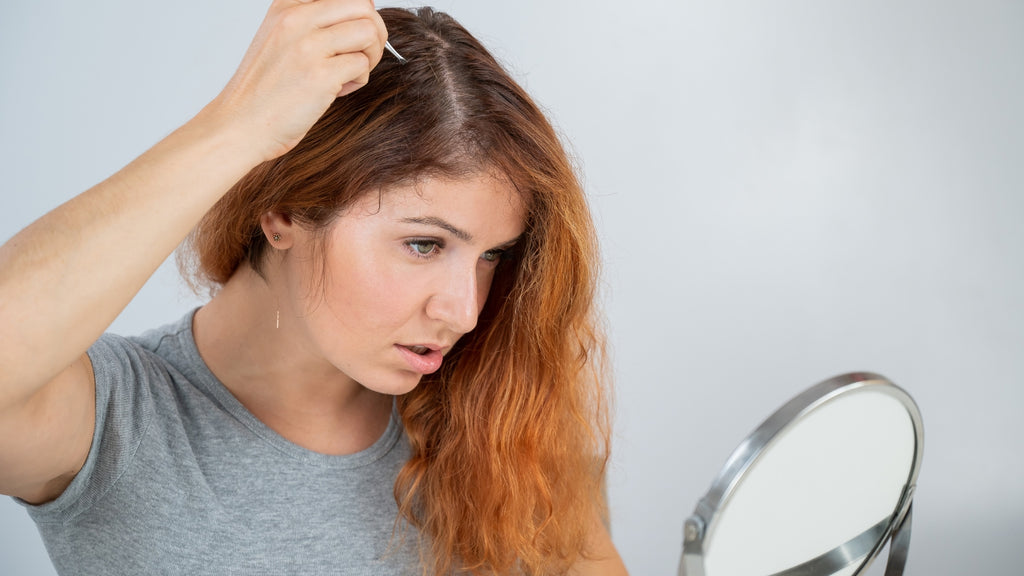 Blog: Young Lady Plucking Premature White Hair with Tweezers