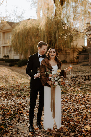 Newly married couple in an embrace posing for wedding photographs