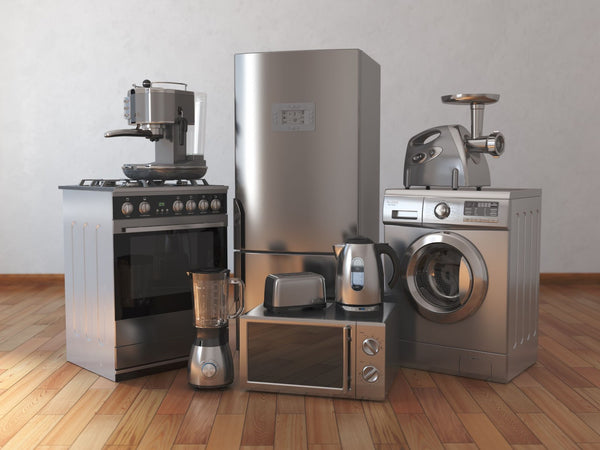 New home kitchen appliances that are all made out of stainless steel.