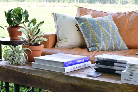 table with coffee table books on it and plants