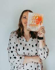 Tana Schuler holding her book