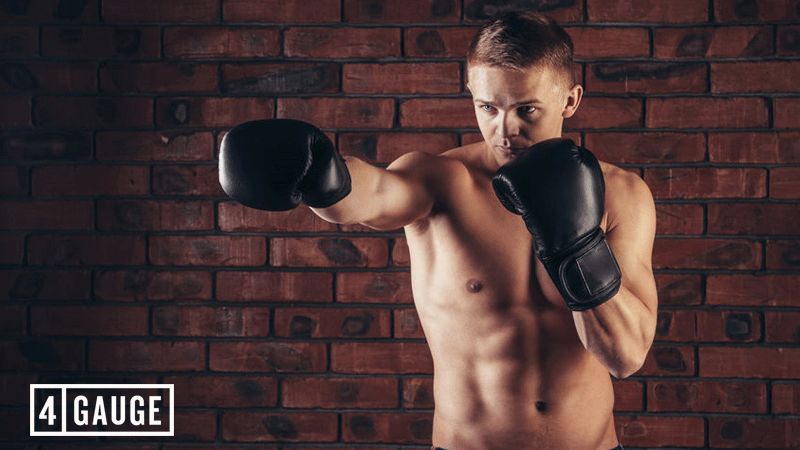 Portrait of mma fighter in boxing pose against brick wall