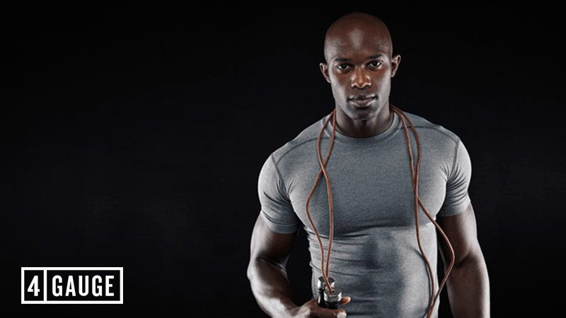 African american man with skipping rope showing muscular arms