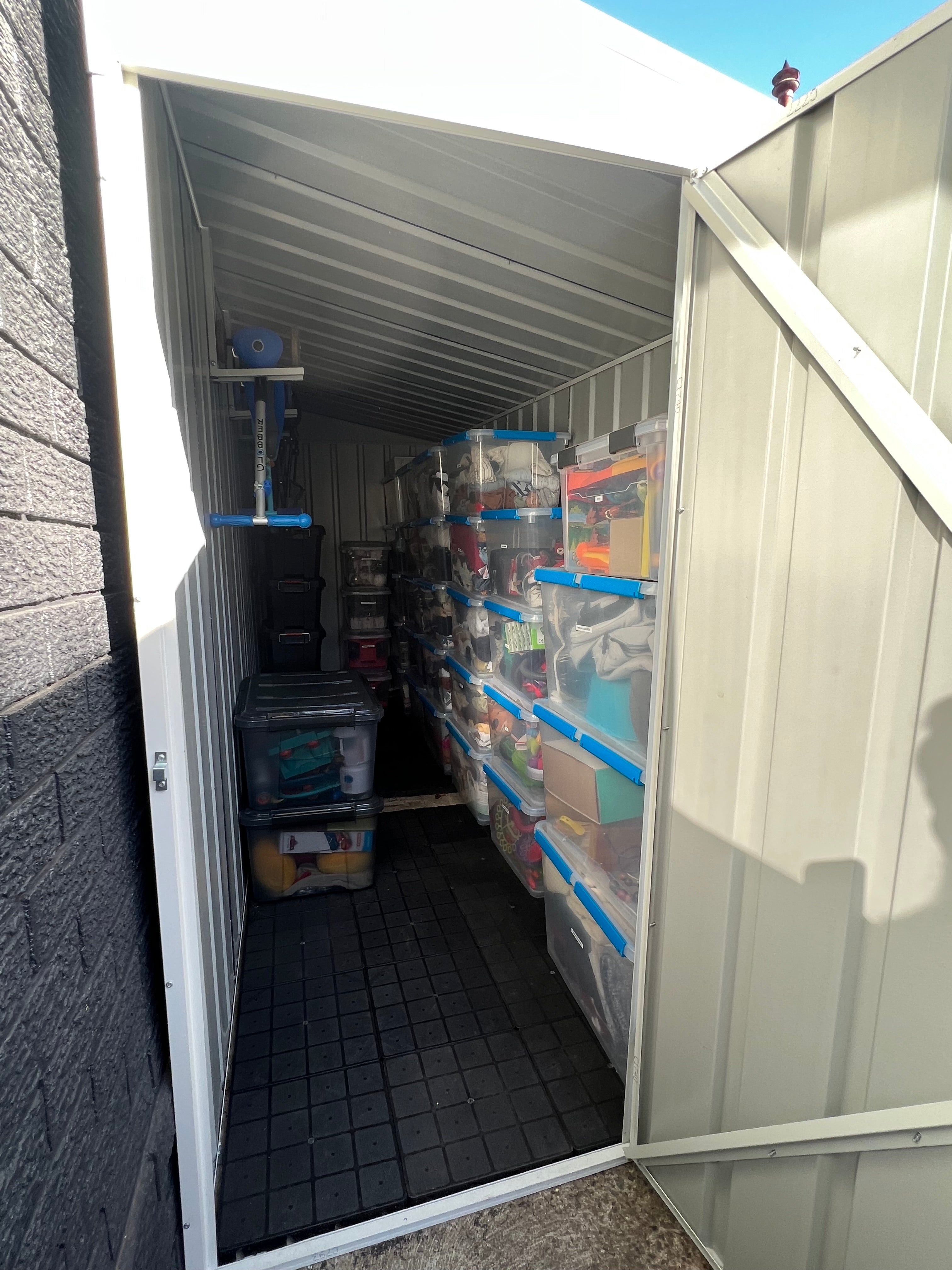 Slate Grey Skillion Roof Shed with boxes stacked inside.