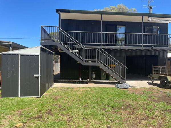 Skillion shed beside a two storey home