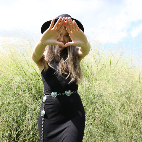 Model wearing Turquoise Bordered Heart Chain Belt in black dress